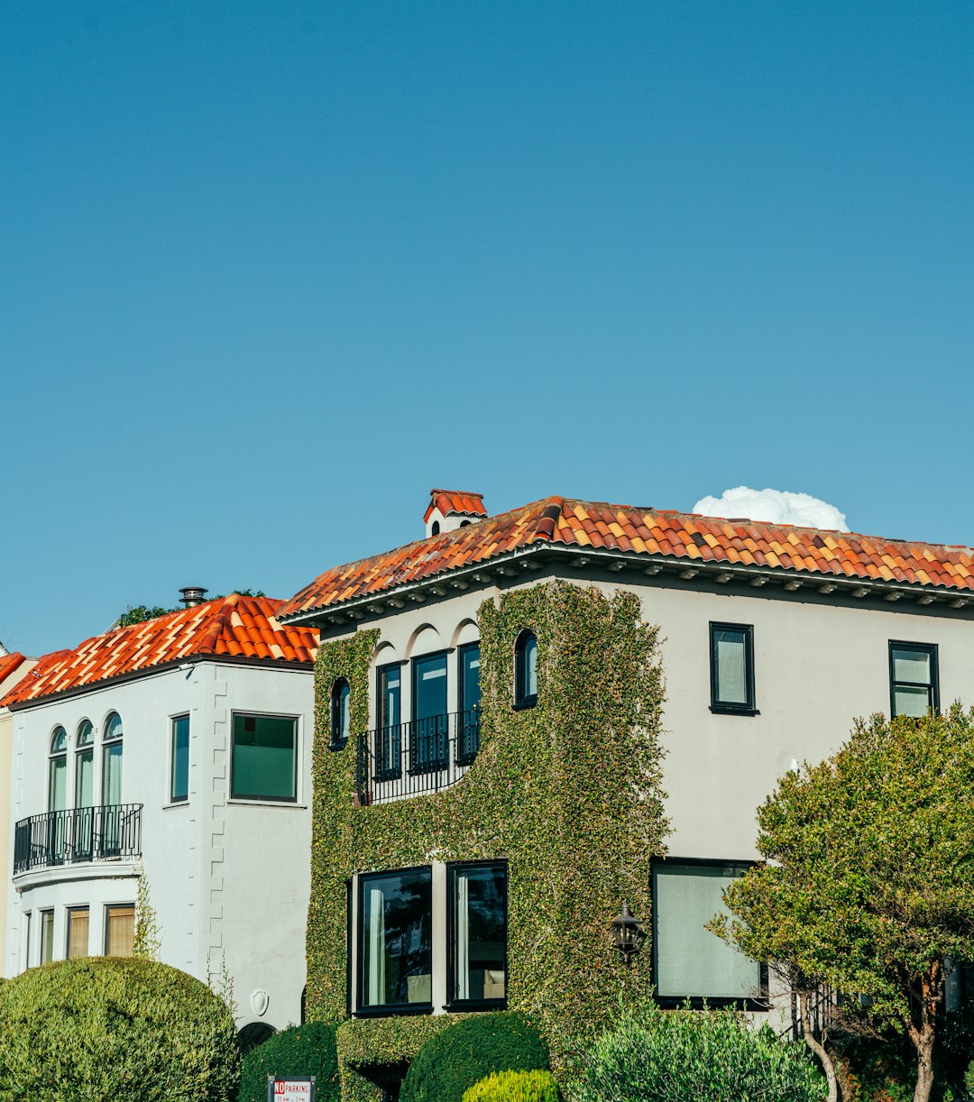 two-houses-with-tiled-roofs-under-a-clear-sky-mjcef-zc8ru